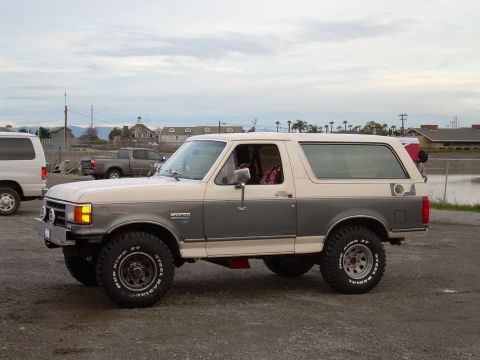 1991 Ford Bronco - This two-tone Ford Bronco is equipped with off-road tires and appears to be lifted.