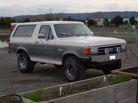 1991 Ford Bronco - This 1991 Ford Bronco is shown from the front three-quarter view with a two-tone paint scheme.