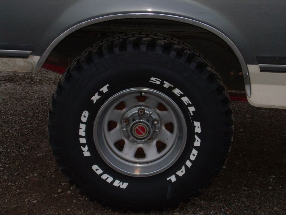 Close-up of a steel radial mud tire with white lettering