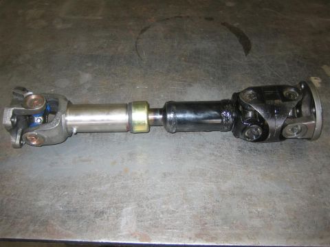 1987 Suzuki Samurai - A driveshaft component is shown against a textured background.