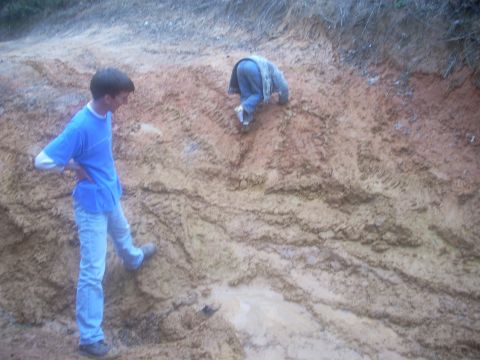 1992 Ford Bronco - Two individuals navigate a challenging muddy terrain.