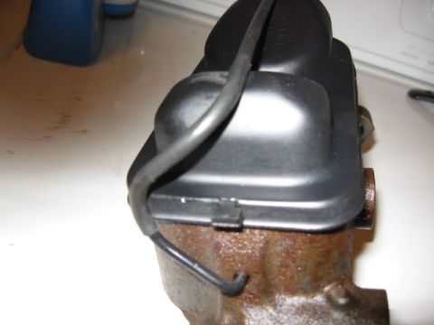 1968 Shelby GT500 - A close-up view of a brake master cylinder, showing rust and a black cap with a wire.
