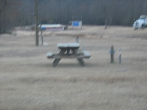 1978 Ford Bronco - A blurry white truck is visible in the distance, parked in an open field.