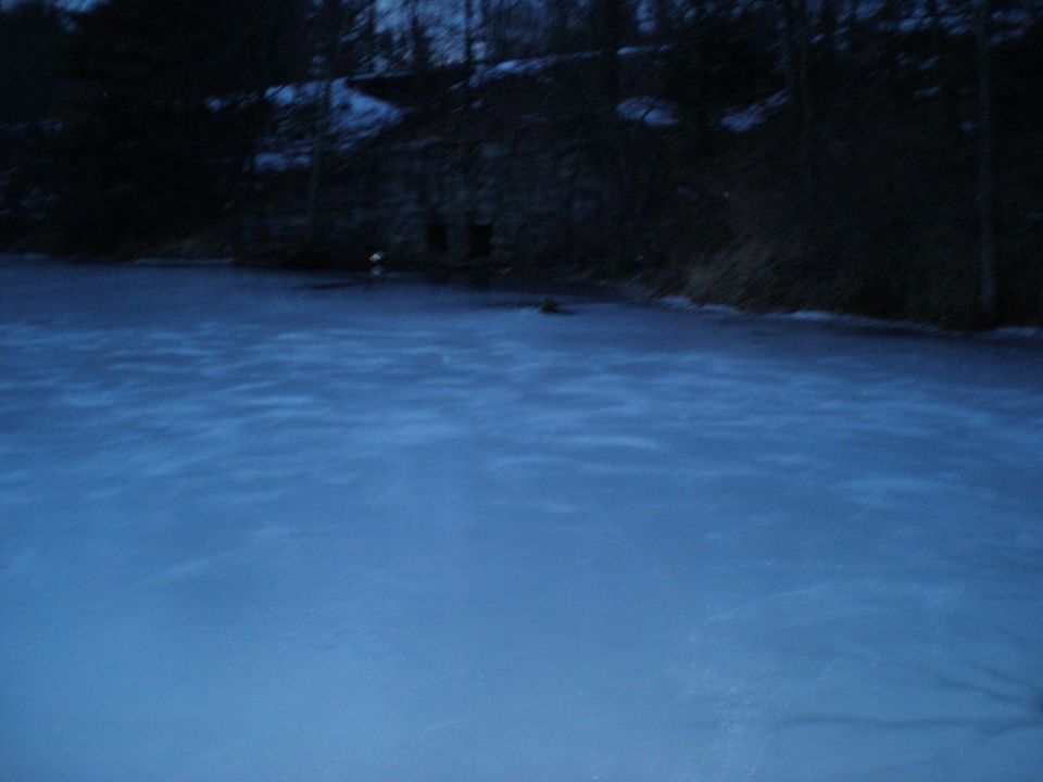 Frozen lake with a building in the background and SUPERMOTORS watermark