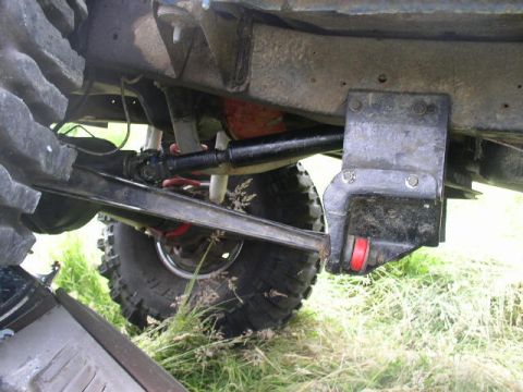 1979 Ford Bronco - Close-up of the undercarriage, showing suspension and large tires, with a Supermotors watermark.
