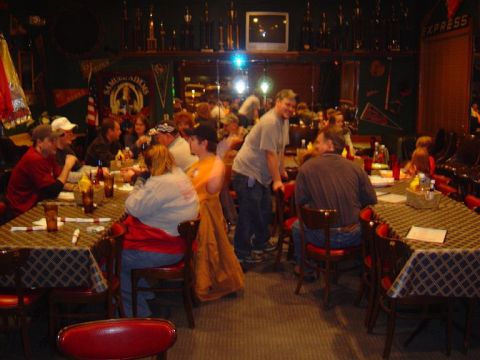 1986 Ford Bronco - A lively restaurant scene with patrons seated at tables, enjoying a meal in a dimly lit atmosphere.