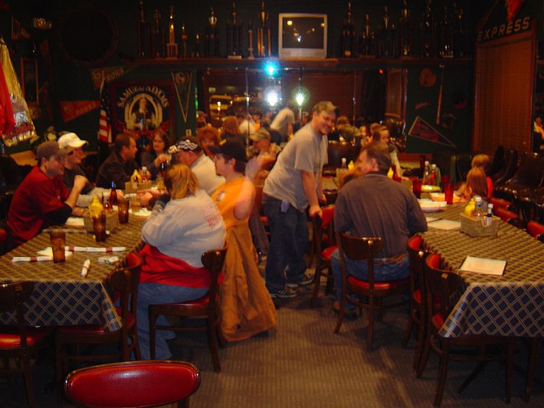 Interior of a busy restaurant with people dining at tables