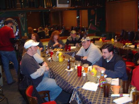 1986 Ford Bronco - A group of people are gathered around tables in a restaurant, enjoying a meal and drinks.
