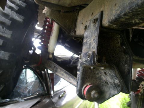 1979 Ford Bronco - Underbody view of a vehicle's suspension and frame, with a large tire visible.