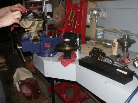 1986 Ford Bronco - Workbench setup for differential repair, showing gears, tools, and cleaning supplies.