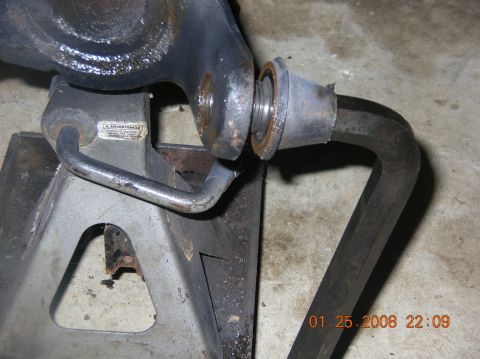 1991 Ford F-150 - A Dana 60 axle part is shown on a jack stand, with a hex wrench inserted into a bolt.