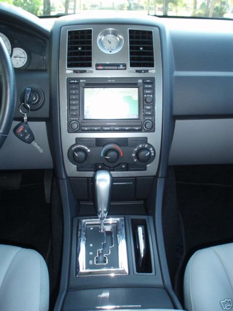 2007 Chrysler 300 - The dashboard and center console of a Chrysler 300, the navigation system and automatic transmission shifter.