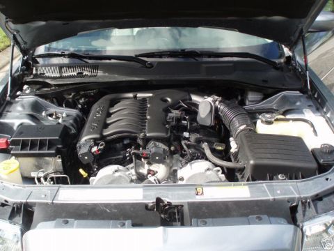 2007 Chrysler 300 - The engine bay of a car is shown with the hood open, revealing the V8 engine and associated components.