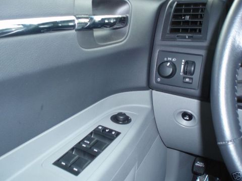 2007 Chrysler 300 - Interior view of a 2007 Chrysler 300 showing the driver's side door panel and dashboard controls.