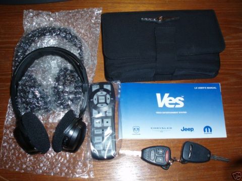 2007 Chrysler 300 - Chrysler VES accessories including headphones, remote, manual, and keys are laid out on a table.