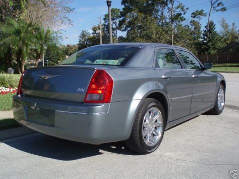 2007 Chrysler 300 - Rear view of a gray Chrysler 300 sedan parked on a street, showing its taillights and trunk.