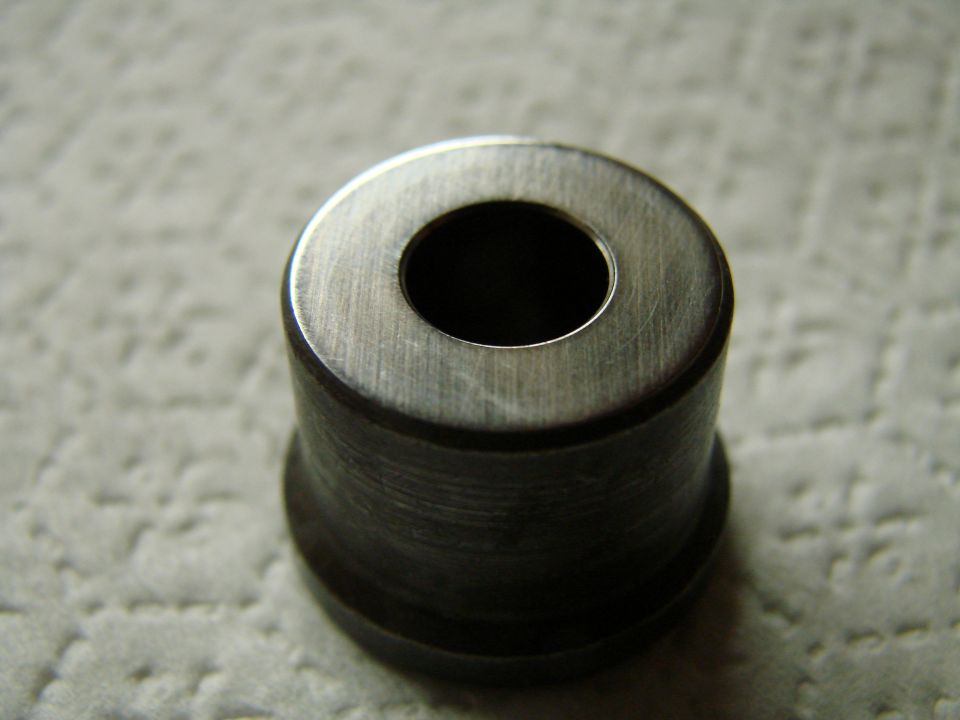 Close-up of a metal bushing with a hole in the center