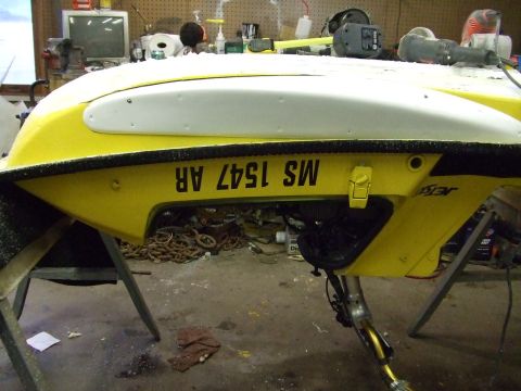 1998 Kawasaki JH1100-A4 1100 ZXi - A yellow and white jet ski hull is shown on stands in a workshop environment.