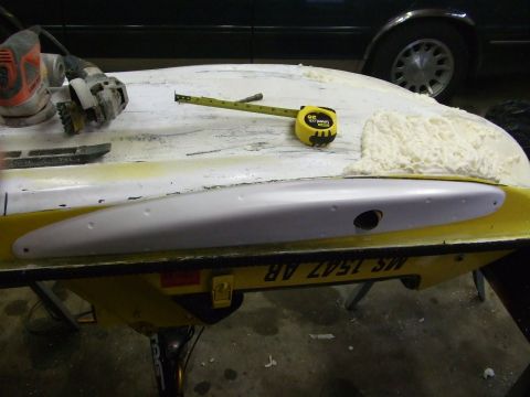 1998 Kawasaki JH1100-A4 1100 ZXi - A section of a jet ski hull is shown with a tape measure and a sander, suggesting repair or modification work.