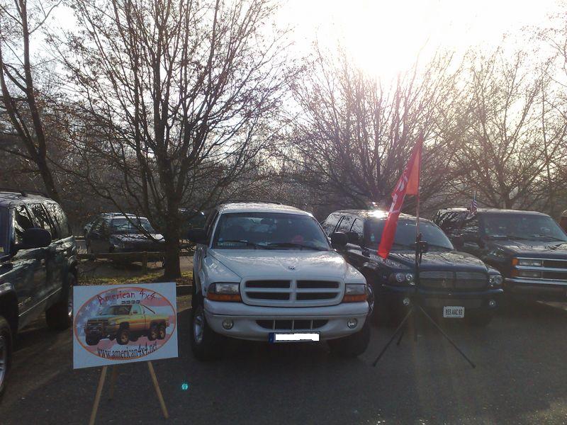 White Dodge Dakota pickup truck parked outdoors with other vehicles