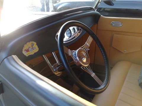 1991 Ford Crown Victoria - The interior of a classic car features a banjo steering wheel and tan upholstery, with a humorous sticker on the dashboard.