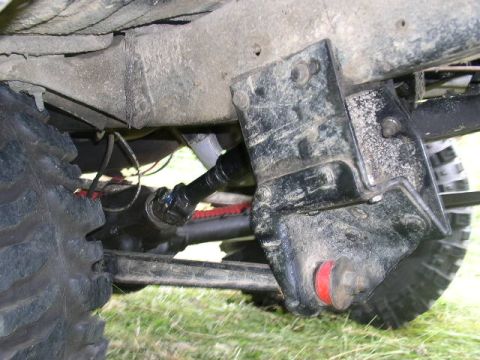 1979 Ford Bronco - Close-up of the undercarriage, showing suspension components and a tire. No specific year or model is identifiable from this view.