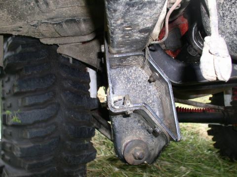1979 Ford Bronco - Detail shot of the suspension and tire of a modified off-road vehicle.