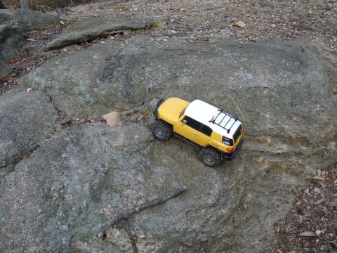 1996 Ford Bronco - RC rock crawler navigating a challenging rocky path.