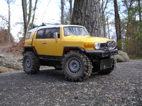 1996 Ford Bronco - A remote-controlled toy vehicle is parked on a large rock in a wooded area.