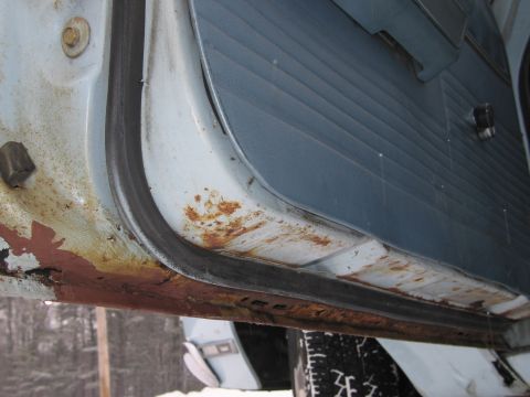 1991 Ford LTD Crown Victoria - The lower door frame and rocker panel show significant rust damage, with the interior door panel visible above.