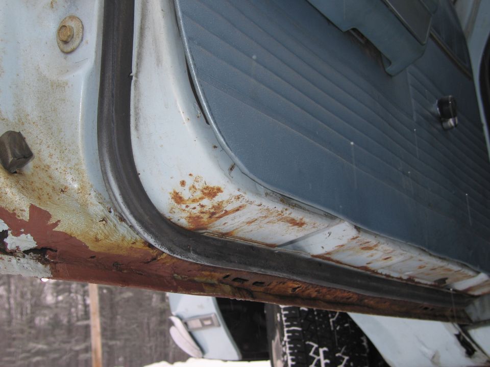 rusted out car door sill and interior panel