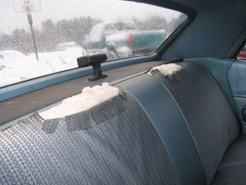 1991 Ford LTD Crown Victoria - Interior view of a car showing damaged seats and other vehicles outside in the snow.