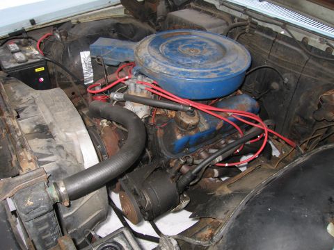 1991 Ford LTD Crown Victoria - The engine bay shows a blue air cleaner assembly and red spark plug wires.