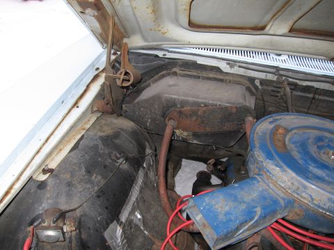 1991 Ford LTD Crown Victoria - The engine bay of a light blue vehicle, with visible rust and aged components, suggests an older model year.