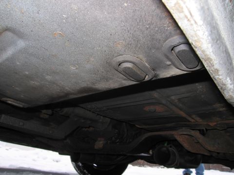 1991 Ford LTD Crown Victoria - The underside of a vehicle is visible, with suspension and exhaust components in view.