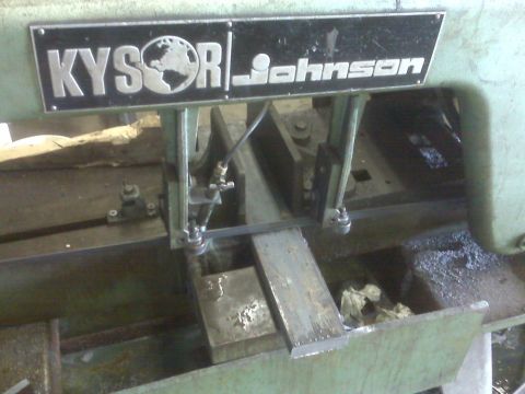 1996 Ford Bronco - A Kysor Johnson metal cutting saw is shown in operation, cutting a piece of metal stock.