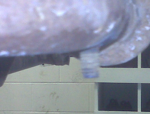 Metal bracket with a bolt and blue markings, attached to an unseen object