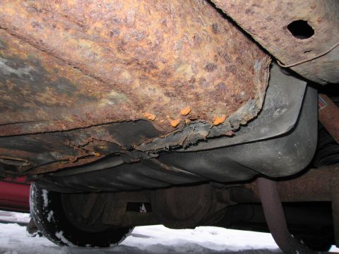1991 Ford LTD Crown Victoria - The underside of the vehicle displays significant rust and corrosion, obscuring any specific year identification.