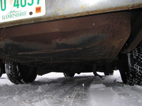 1991 Ford LTD Crown Victoria - Underside view of a vehicle with a New Hampshire license plate, parked in snow.