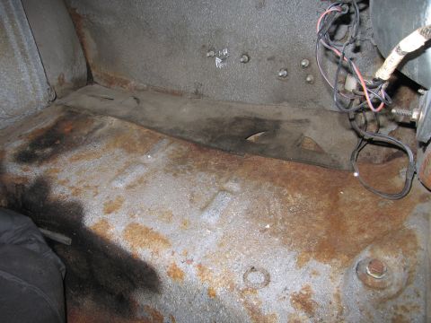 1991 Ford LTD Crown Victoria - The interior floor shows significant rust and wear, with exposed wiring and fasteners.