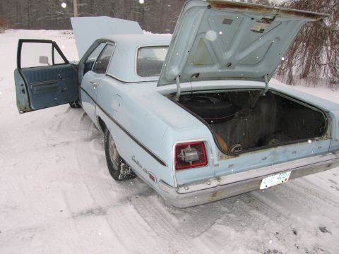 1991 Ford LTD Crown Victoria - Light blue 1969 Ford Custom 500 sedan with hood and trunk open, sitting in the snow.