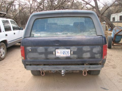 1982 Ford Bronco - Rear view of a dark blue Ford Bronco with an Arizona license plate, parked next to a white SUV.