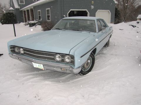 1991 Ford LTD Crown Victoria - A light blue 1969 Ford Custom 500 sedan sits in a snowy driveway in front of a house.