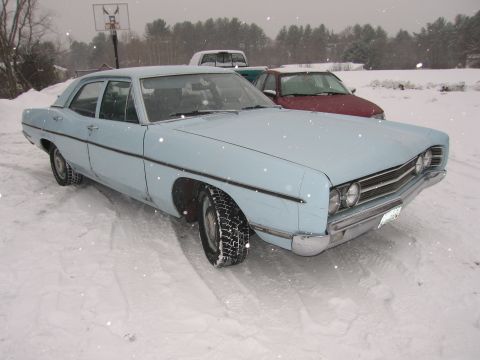 1991 Ford LTD Crown Victoria - A light blue 1969 Ford sedan sits in the snow, with other vehicles visible in the background.
