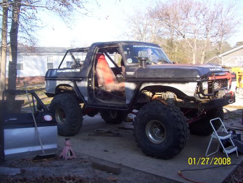 1978 Ford Bronco - This modified 1978 Ford Bronco features a roll cage and oversized tires, indicating significant off-road customization.