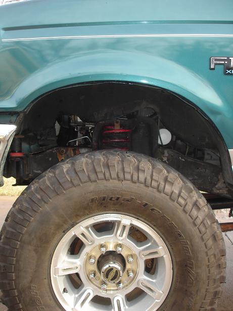 1996 Ford F-150 - Close-up of the front wheel and fender assembly on a 1996 Ford F-150 truck.