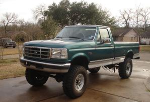 1996 Ford F-150 - A green Ford F-150 pickup truck is shown from a three-quarter front angle, parked on a paved surface.