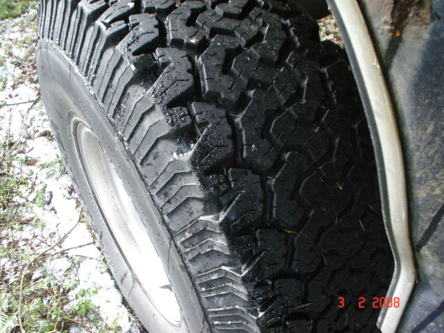 Close-up of a knobby off-road tire with water droplets