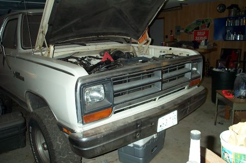 1996 Ford Bronco - Front view of a white pickup truck with its hood raised, revealing the engine compartment.