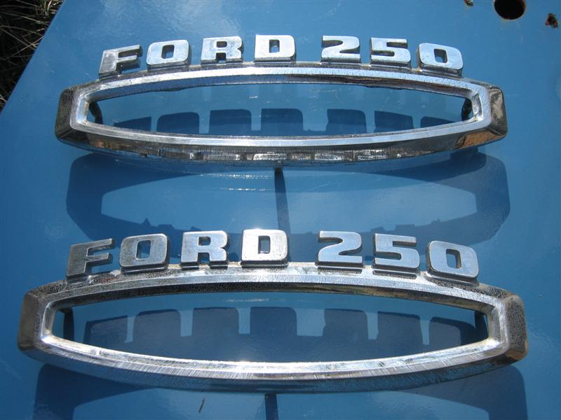Two chrome FORD 250 emblem trim pieces on a blue surface